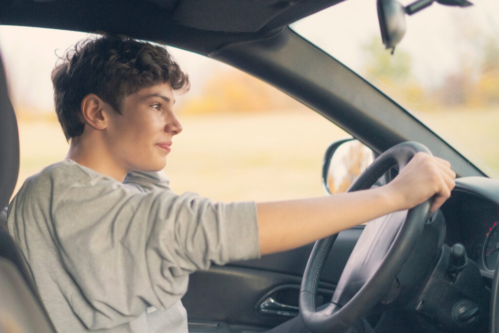 young teenager learns how to drive the car
