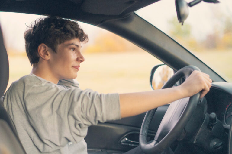 young teenager learns how to drive the car
